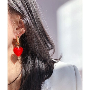 French retro style Murano red glass heart earrings with elegant gold hoops on model