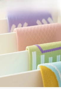 Detail of multi-color five-finger socks showing eco-friendly knit texture on display rack