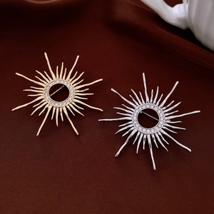 Detail view of vintage sunburst brooches in gold and silver plating with cubic zirconia