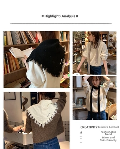 Detail view of soft white and black knitted triangle scarves with elegant tassel edges