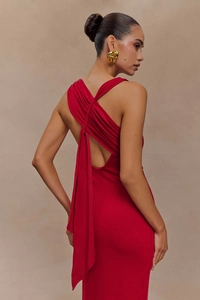 Detail of red backless dress featuring elegant criss-cross straps and twist design