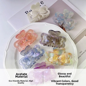 Detail of high-quality acetate heart hair claws with rhinestone center in various colors