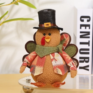 Detail of Thanksgiving turkey plush with maple leaf vest and black top hat decoration
