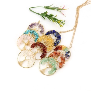 Macro detail of handmade wire wrapped tree of life pendant with colorful natural crystals