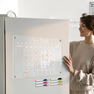 Magnetic acrylic weekly calendar on fridge with woman smiling and six colored markers