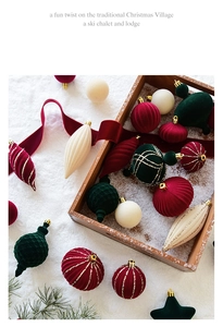 Detail of burgundy and cream velvet Christmas ornaments with gold glitter accents