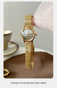 Macro detail of GEDI gold watch with colorful mother-of-pearl dial and Roman numerals