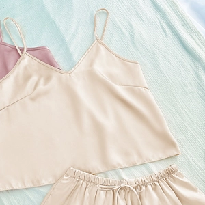 Women's two-piece champagne satin pajama set with V-neck camisole top and drawstring shorts
