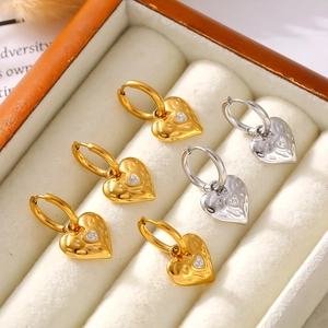 Hammered heart earrings with diamonds in 18k gold plated stainless steel on velvet