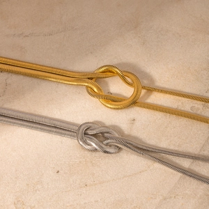 Detailed view of 16k gold and silver stainless steel knotted herringbone chain necklaces