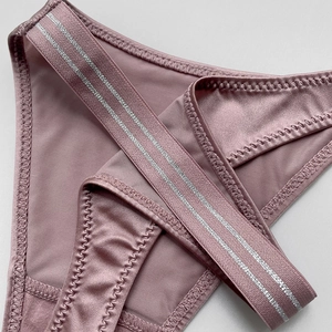 Women's seamless ice silk thong with dual silver elastic waistbands in dusty pink