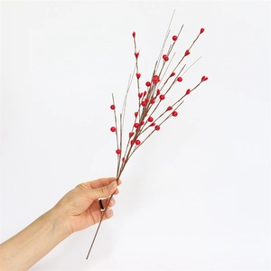 Detailed view of vivid red artificial berry branch stems for festive holiday decorations