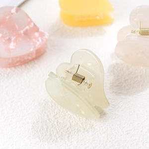 Mini heart-shaped acetate hair claw clips in colorful jelly tones for women and girls
