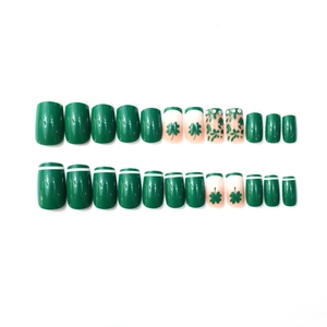 Green French press-on nails with shamrock patterns and rhinestones for St. Patrick's Day