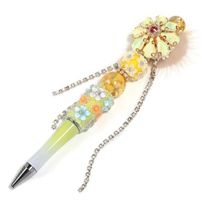 Detail of DIY beadable pen with crystal flower, plush base and rhinestone tassel