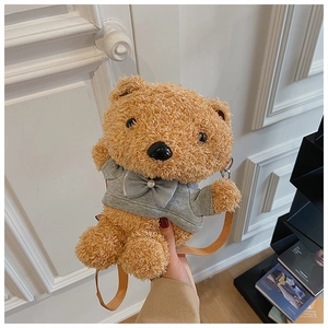 Detail of plush teddy bear crossbody bag with grey hoodie, ribbon and pearl decoration