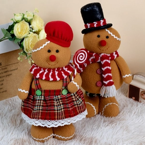 Christmas gingerbread man and woman plush set with chef hats on white faux fur background