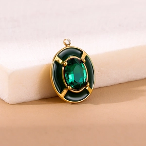Vintage oval pendant with emerald green gemstone and dark green enamel in golden setting