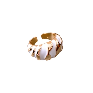 Golden and white croissant twist open ring with irregular textured enamel pattern