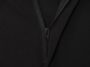 Close-up of high-quality metal zipper and durable fabric on black stylish trousers