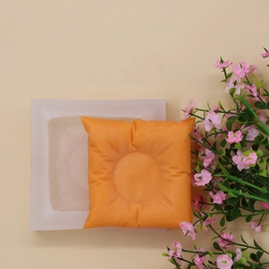 DIY silicone pillow-shaped candle mold with sun pattern and finished wax candle