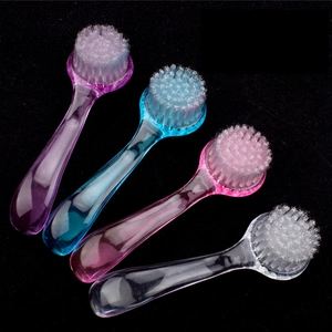 Colorful set of four round nail dust brushes with transparent handles for manicure care