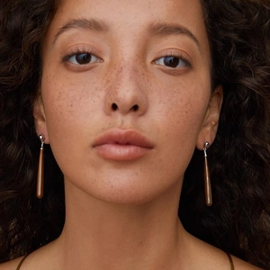 Elegant teardrop drop earrings with wood grain and white mother of pearl on female model