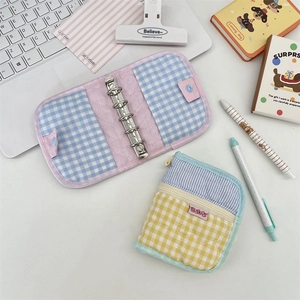 Close-up of quilted fabric 6-ring binder with lavender trim and checkered inner lining
