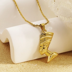 Golden Nefertiti portrait pendant necklace with intricate rope chain on sand base