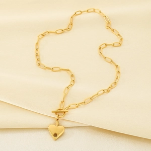 Detail of 18K gold plated heart pendant with OT buckle on paperclip link necklace