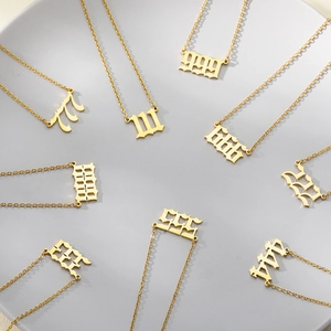 Minimalist gold stainless steel angel number necklace set from 111 to 999 on display
