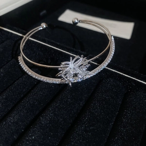 Close-up of double-layer silver bangle with zircon fireworks and snowflake center detail