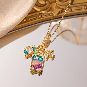 Golden travel theme necklace with airplane, camera and happy travel suitcase charms