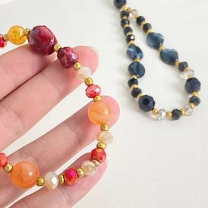 Detail of colorful resin bead phone chains with crystal accents and floral patterns