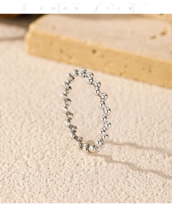 Macro shot of S925 sterling silver beaded ring on a textured stone surface
