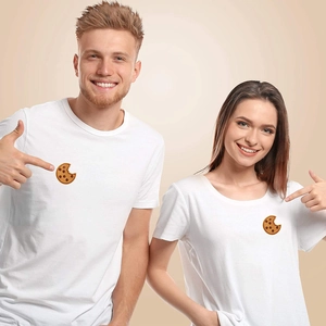 Close-up of chocolate cookie embroidery patch on white T-shirt worn by couple models