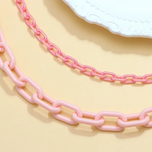 Detail of pink double-layered acrylic waist chains with thick and fine link textures
