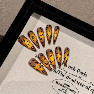 Handmade almond cat eye press-on nails with amber leopard print in a display box