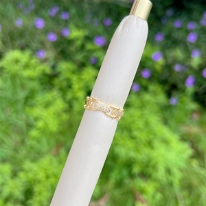 Close-up of 18K gold-plated chain ring with micro-pave cubic zirconia on outdoor stand