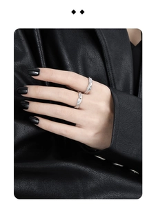 Detailed close-up of a minimalist silver S925 couple ring set with sparkling zircon inlay
