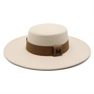 Flat top wide brim wool felt boater hat in beige with coffee ribbon and metal M logo