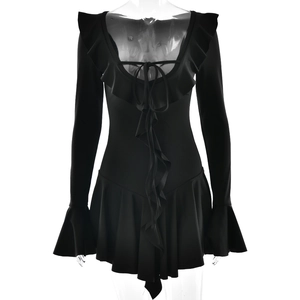 Detail of black long-sleeve dress featuring elegant ruffles and V-neck tie closure