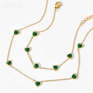 Detail of golden heart necklace with green zircons and adjustable lobster clasp