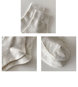 Detail of cream cotton ankle socks showing high-density knit cuffs, heel and toe seams