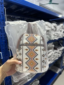Close-up of bohemian canvas chest bag with geometric patterns in protective plastic bag