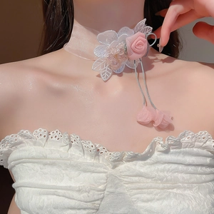 Close-up of pink chiffon rose choker with lace embroidery and delicate petal charms