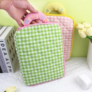 Detailed view of quilted plaid iPad sleeve with Melody embroidery and horseshoe handle