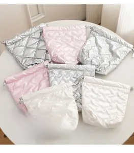 Quilted satin drawstring bags with heart and bow patterns in pink, silver and white