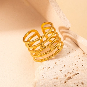 Macro shot of gold-plated multi-layer titanium steel ring with subtle circular details