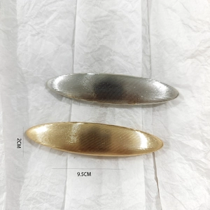 Detail view of 9.5cm brushed alloy spring hair clips in gold and silver finish